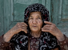 The old woman fixing her scarf 