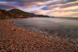 Sunset on the beach of pebbles 