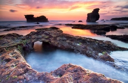 perforated rock on the beach melasti 