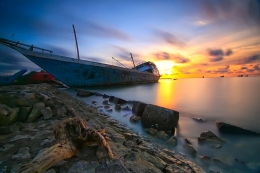 The Damaged Wooden Boat_and Sunset_ 