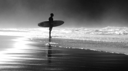 The surfer between the fog and the sea. 